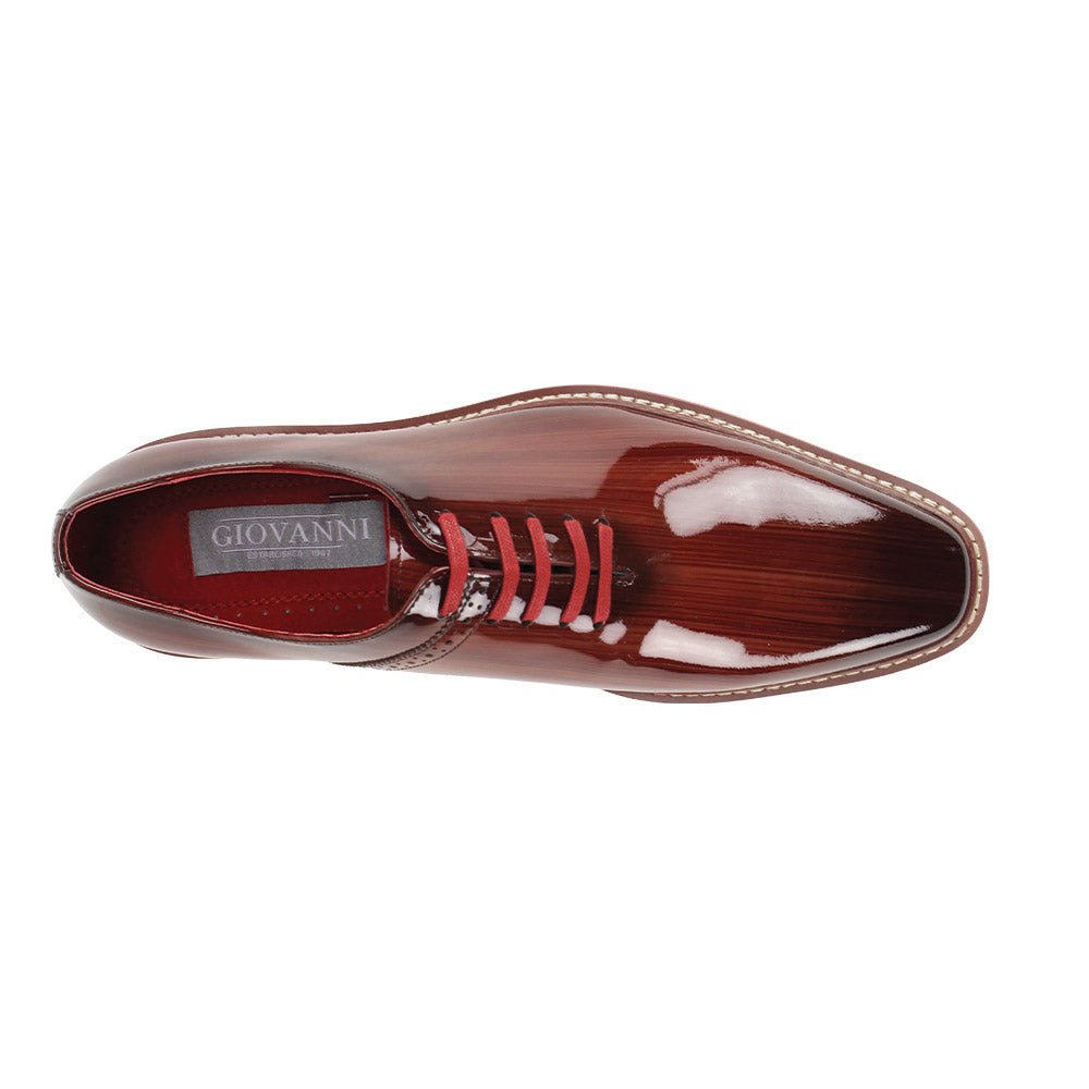 The GIOVANNI Giovanni Ruben Brown Patent Leather Shoes feature a glossy brown finish, red laces and interior, plus a thick lightweight white and brown serrated sole.
