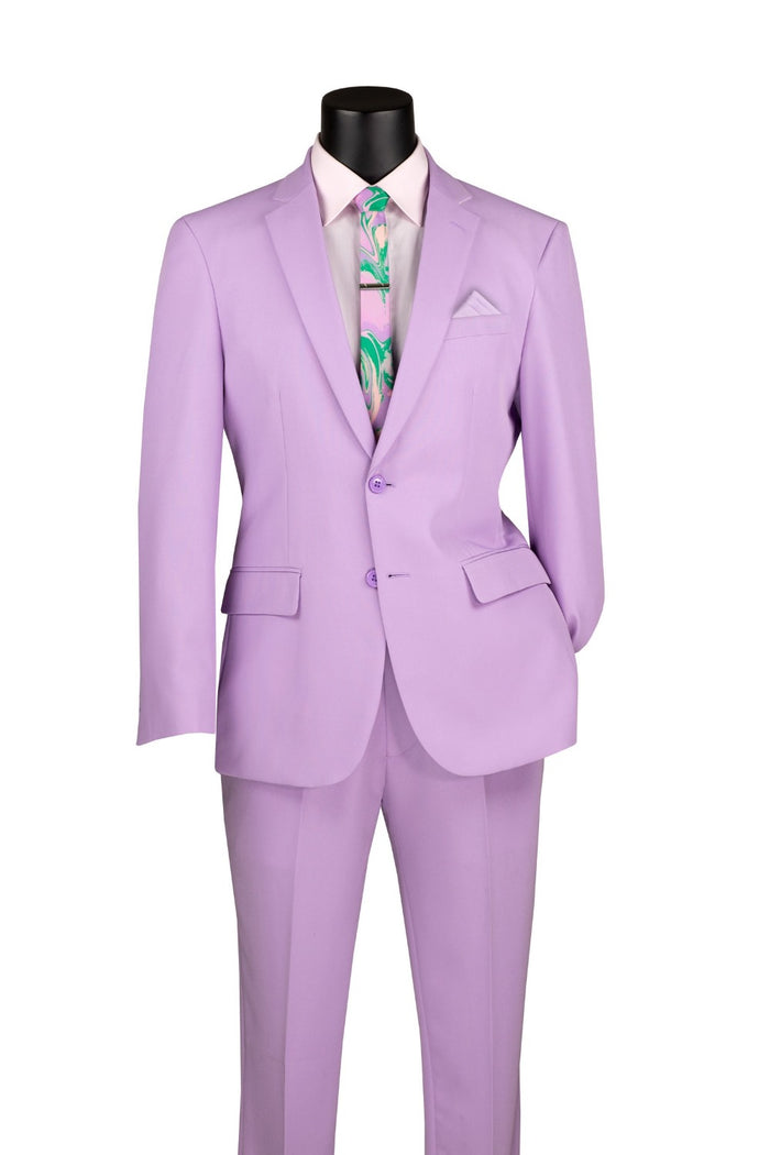 Displayed on a mannequin, the Vinci Suits Slim Fit 2 Piece 2 Button Business Suit Lavender S-2PP comes with matching pants, a cream shirt, and a colorful tie. The wrinkle-resistant fabric keeps it looking sharp all day.