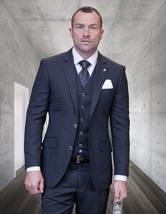 A man wearing the STATEMENT CLOTHING | SALOTE-BLACK modern fit plaid suit and tie by Statement Clothing stands in a minimalist hallway, holding a folder in his left hand.
