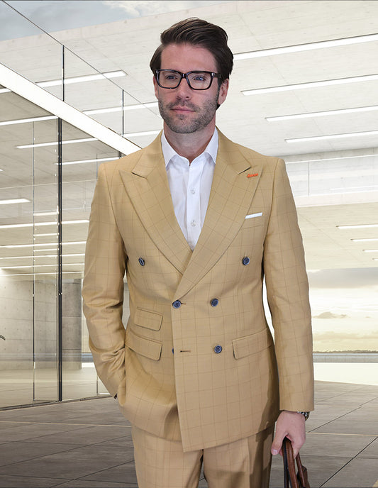 A man in the STATEMENT CLOTHING | SD-104-CAMEL modern fit, light tan double-breasted suit from Statement Clothing, paired with a white shirt and glasses, stands in a glass-walled building with his hand in his pocket.