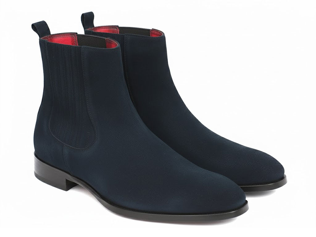 Introducing the Paul Parkman Navy Suede Chelsea Boots - SD875NVY, crafted to order with a sophisticated suede upper in navy blue, complemented by black elastic sides and a vibrant red interior lining, all showcased elegantly against a white background.