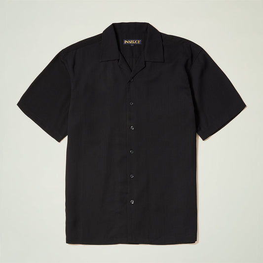 The Inserch Crepe Camp Collar Shirt SE9356-00001 in black by Inserch is a short-sleeve, button-up poly-crepe shirt with a camp collar, shown flat on a light background.