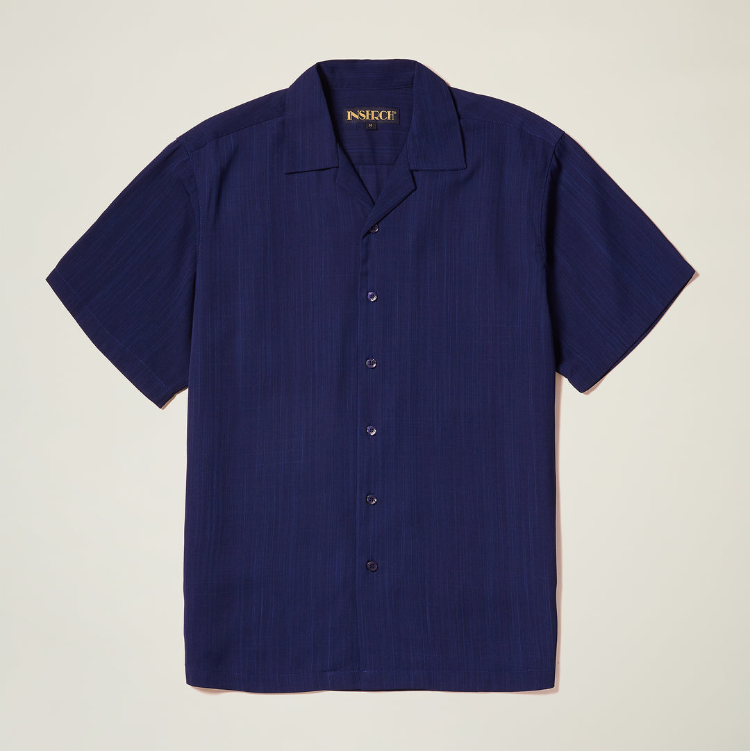 The Inserch Crepe Camp Collar Shirt SE9356-00011 in solid navy blue poly-crepe fabric by Inserch is shown with short sleeves, laid flat on a light background.