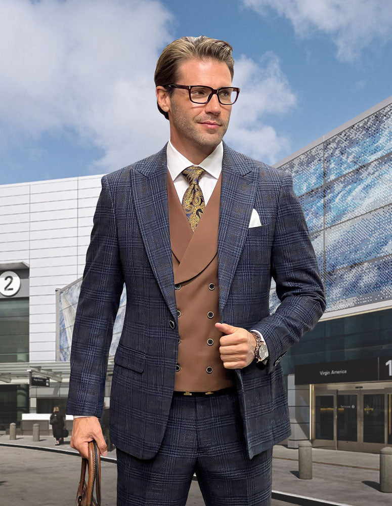 A man in a Statement Clothing SORENTO-MIDNIGHT modern fit plaid Italian wool suit with a brown waistcoat and tie stands outside a sleek airport terminal, holding a briefcase.