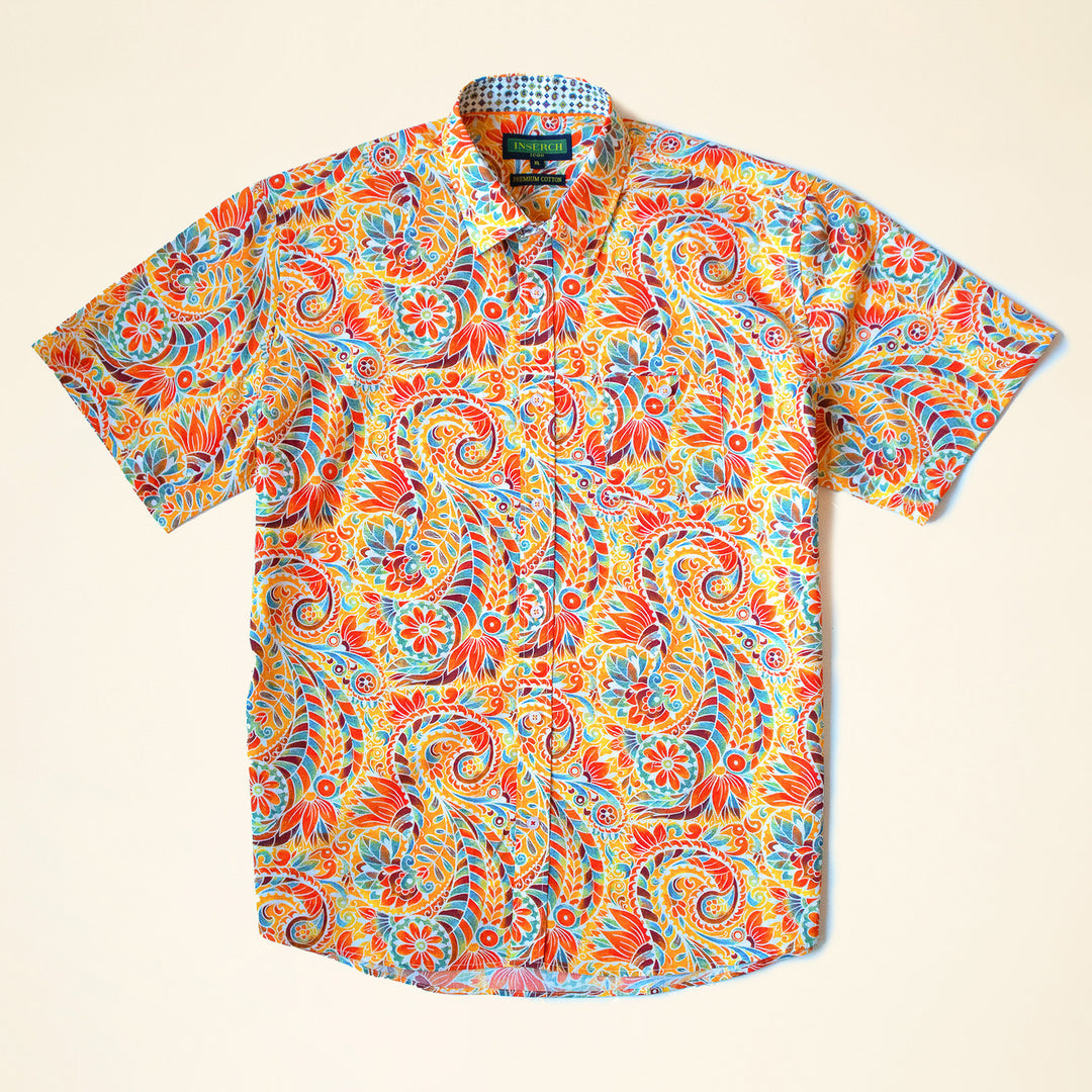 The Inserch SS Paisley Print Shirt SS011-00029 Orange is a short-sleeve premium cotton button-up, featuring a multicolored paisley and floral pattern in red, yellow, blue, and green, shown laid flat on a light background.