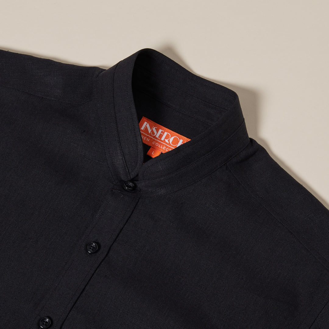 The Inserch Linen 2pc Set (SS716) in Black by Inserch features a black button-up mandarin-collar shirt with an orange tag inside the neckline, laid flat to display its premium linen craftsmanship.