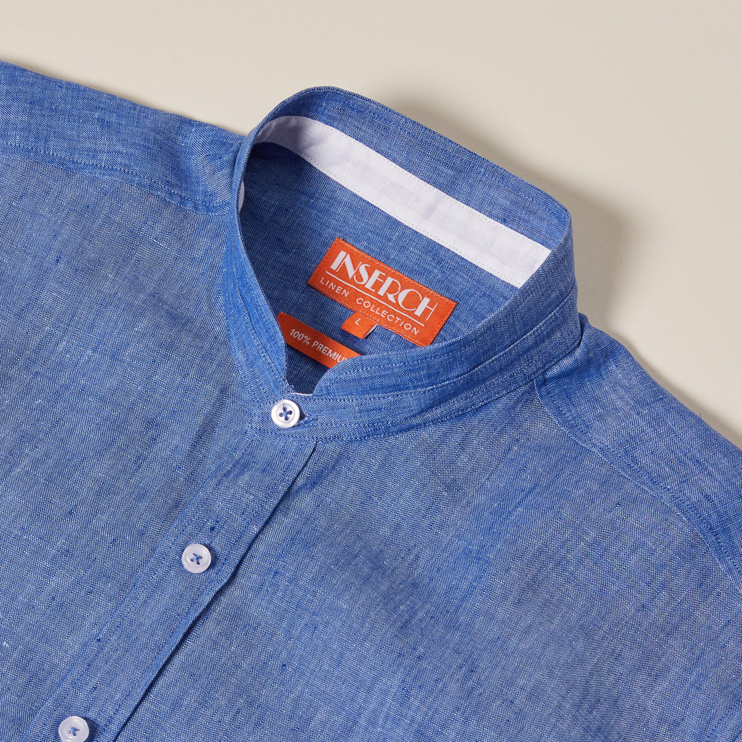 The Inserch SS Banded Collar Linen Shirt in Blue Wave, SS716-00127, features a blue flax linen design with a banded collar, pearlized buttons, and an orange label inside the collar area.