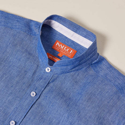 The Inserch SS Banded Collar Linen Shirt in Blue Wave, SS716-00127, features a blue flax linen design with a banded collar, pearlized buttons, and an orange label inside the collar area.