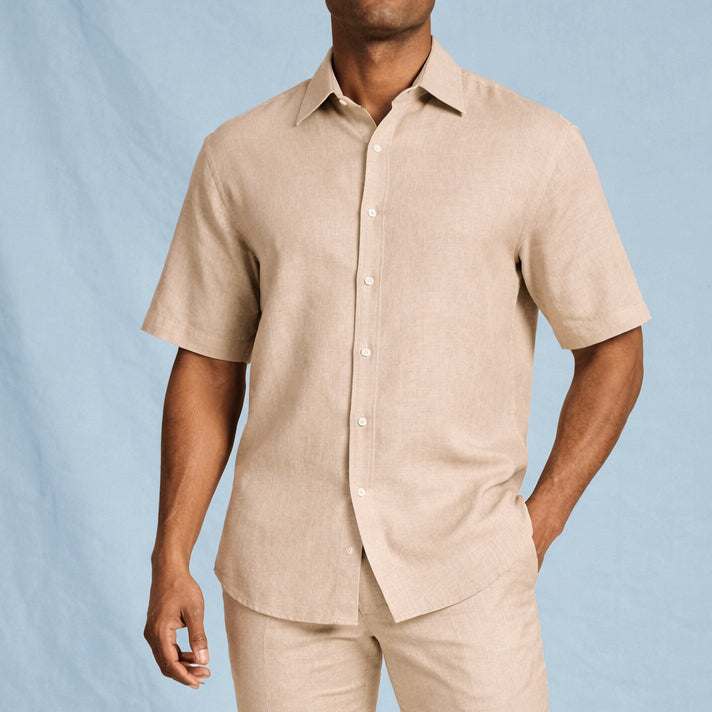 A man wearing the Inserch SS Linen Shirt SS717-00006 in Oatmeal by Inserch and matching pants stands against a light blue background.