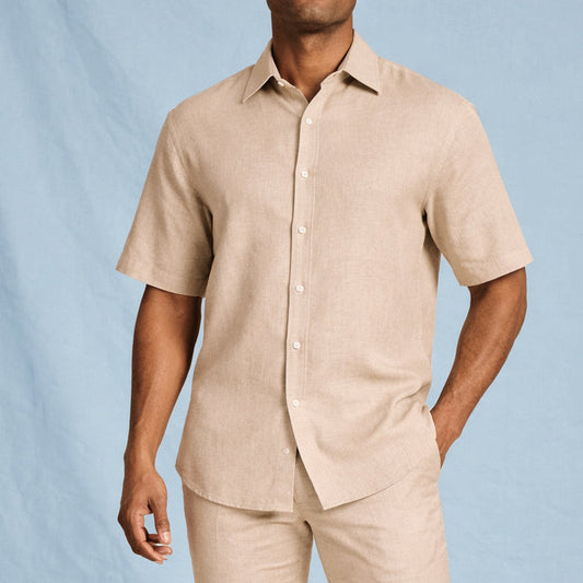 A man wearing the Inserch SS Linen Shirt SS717-00006 in Oatmeal by Inserch and matching pants stands against a light blue background.