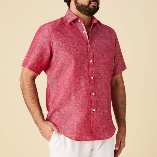 A man wears the Inserch SS Linen Shirt SS717-00030 in red by Inserch, featuring short sleeves and a subtle textured pattern with cotton floral print trim, paired with white pants against a plain beige background.