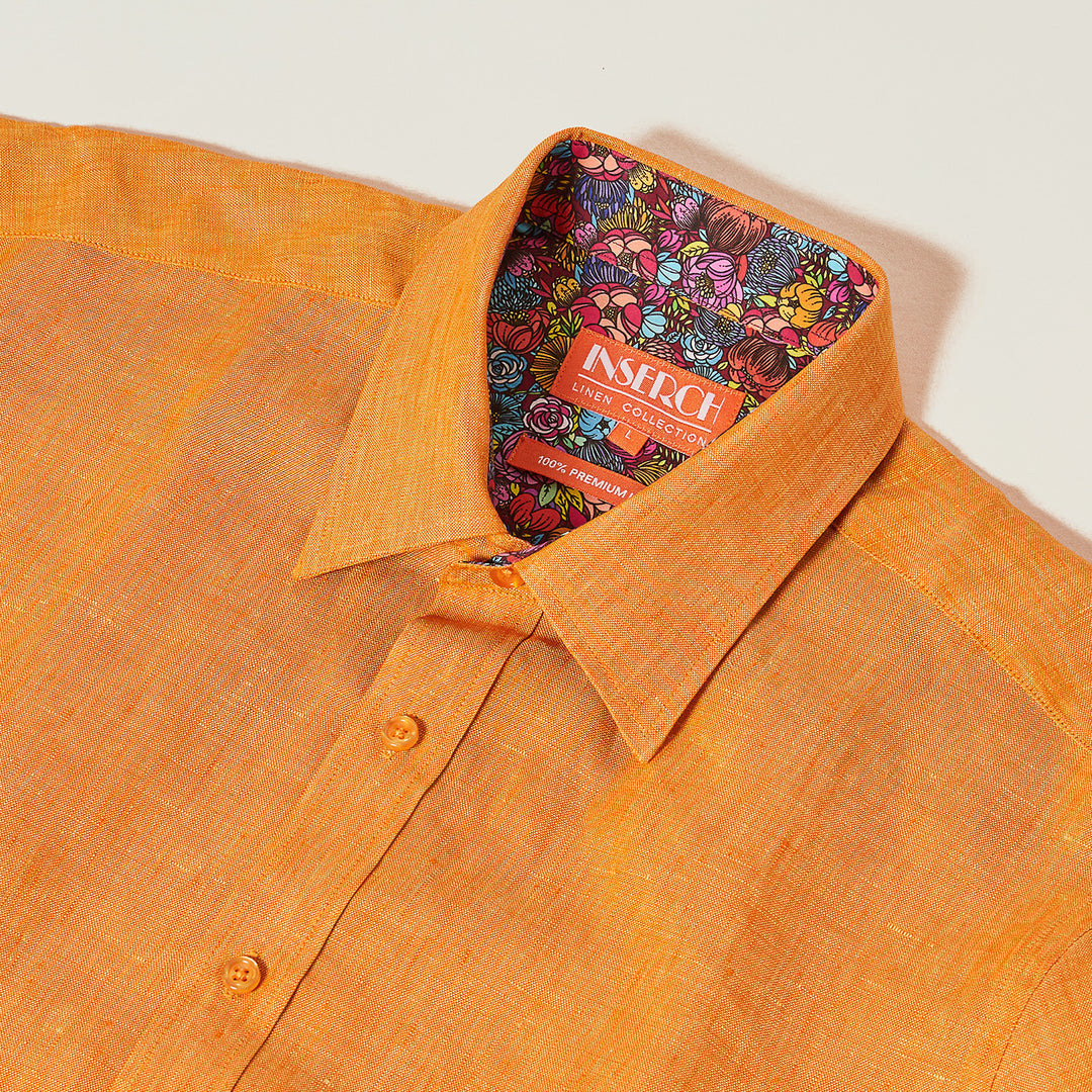 The Inserch SS Linen Shirt (SS717-00191 Sunburst) is a premium orange linen shirt with a vibrant cotton floral print interior collar, featuring the "Inserch Linen Collection" label.