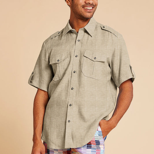 Man wearing the Inserch Linen 2pc Set (Shirts and Pants) (SS718) in Oatmeal by Inserch, featuring a short-sleeve button-up shirt with chest pockets and matching pants, standing against a beige background.