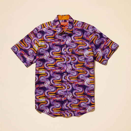 The Inserch SS Optic Wave Linen Shirt SS7916-00068 in Eggplant is a short-sleeved pullover featuring a vibrant wavy pattern in purple, orange, and yellow. Made from a comfortable linen-rayon blend, it effortlessly enhances your wardrobe.