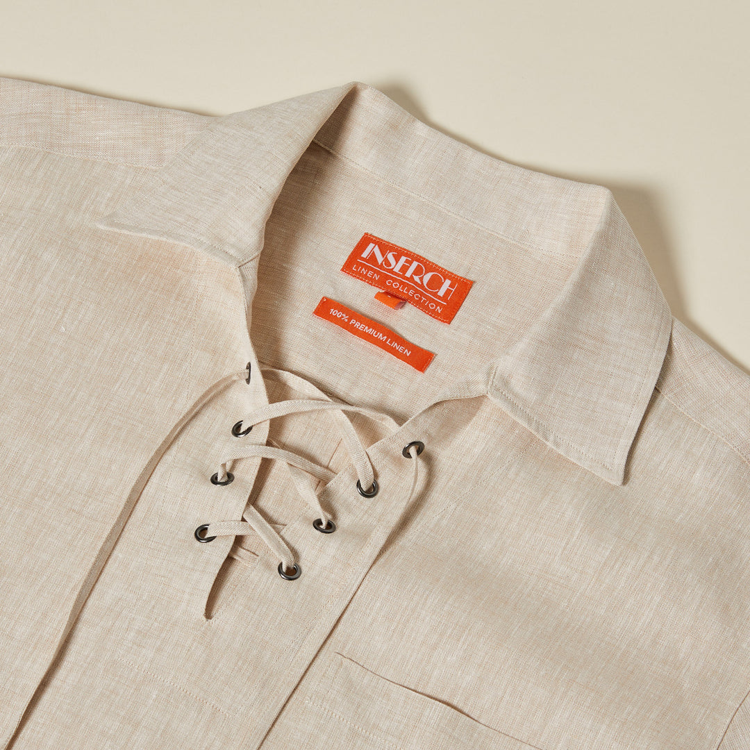 The Inserch SS Linen Lace Front Pullover Shirt (SS811-00006 Oatmeal) is a beige European flax linen shirt with a lace-up v-neck, collar, and red "Inserch Linen Collection" label inside.