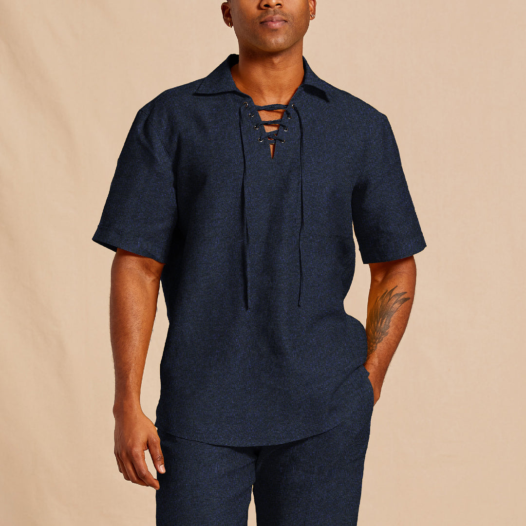 A person wears the Inserch SS Linen Lace Front Pullover Shirt SS811-00036 Ink by Inserch with matching pants, standing against a beige background.