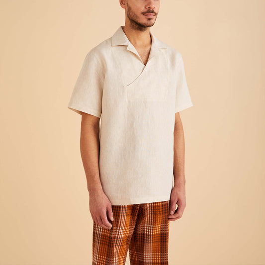 A man wearing an Inserch Linen Pull Over Shirt SS813-00006 Oatmeal and orange plaid pants stands against a plain background.
