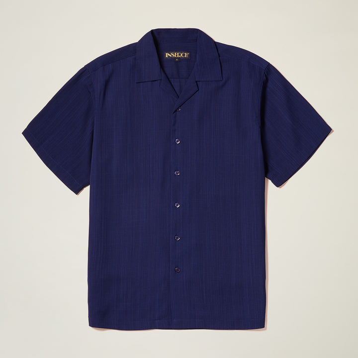 The Inserch Crepe Camp Collar Shirt (SS9356-00011) in solid navy blue features a regular fit and high-twist poly-crepe fabric, showcased by Inserch against a neutral background.