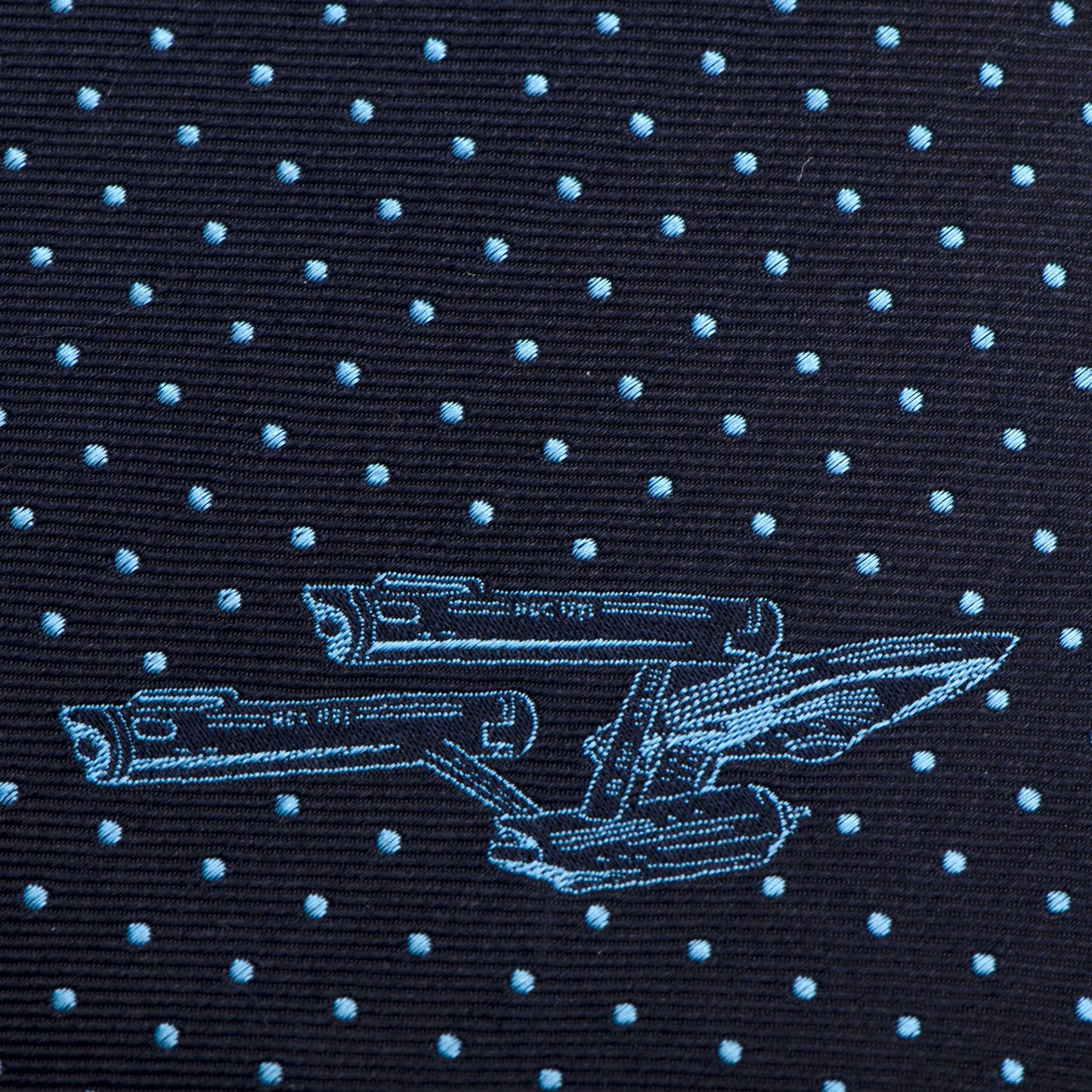 The Star Trek Enterprise Dot Blue Men's Tie by Cufflinks.com features a navy silk design with light blue polka dots and the USS Enterprise, perfect for fans.