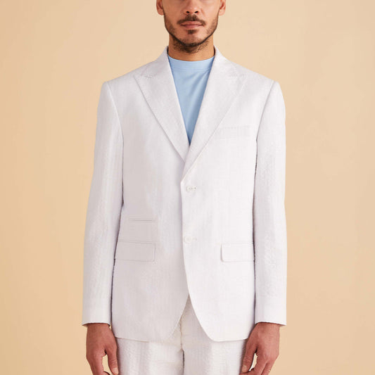 Someone is donning an Inserch Seersucker Stripe Blazer SU660155-00002 in white, featuring a peak lapel, over a light blue shirt against a neutral background.