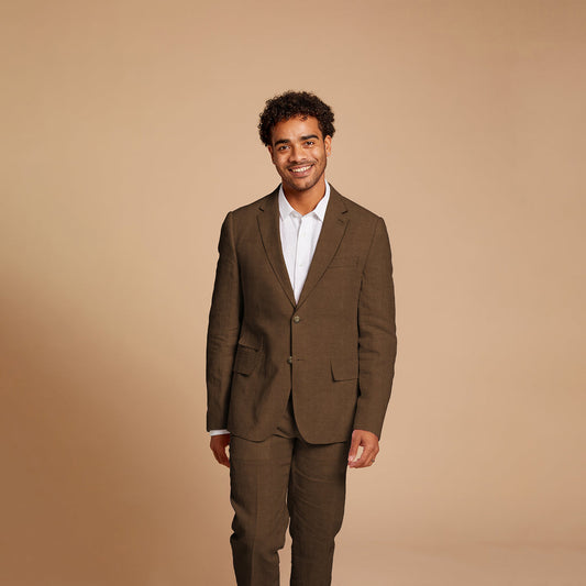 A man in an Inserch Slim Linen Suit SU880-00064 Mocha and a white shirt smiles against a beige background.
