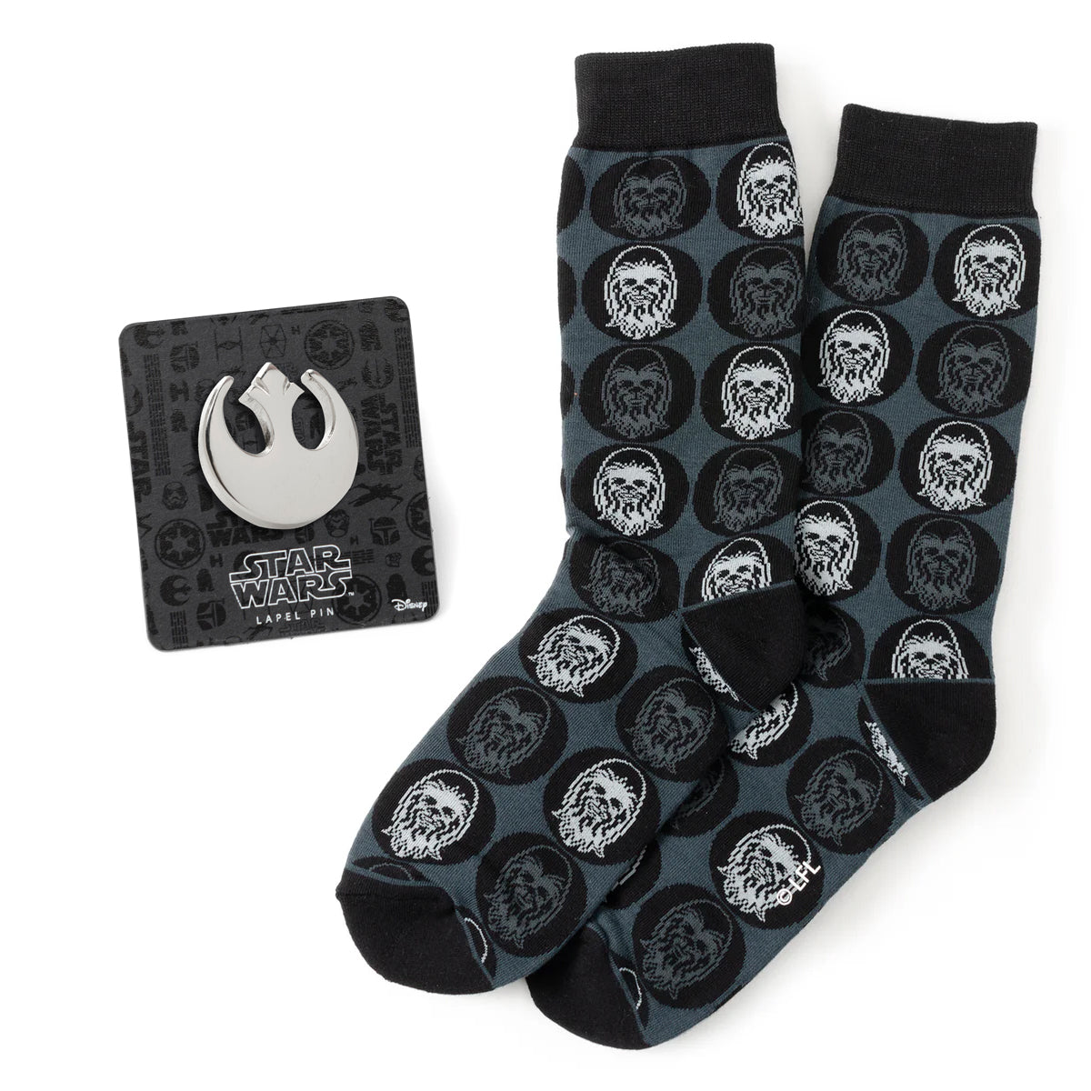 The Star Wars Chewbacca Black Dress Socks and Rebel Alliance Starbird Crest Lapel Pin Gift Set by Cufflinks.com includes Chewbacca-themed socks and a metallic lapel pin—an ideal gift for Star Wars fans.