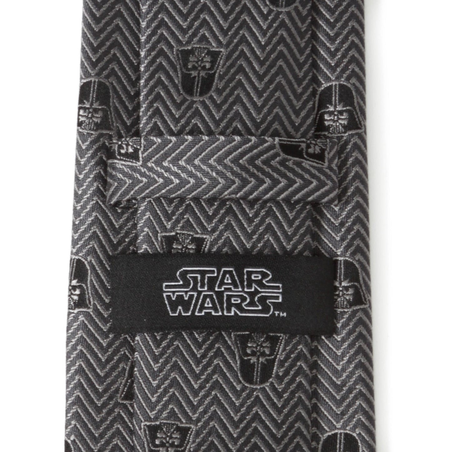 The Cufflinks.com Star Wars Darth Vader Black and Gray Herringbone Tie features a herringbone pattern with repeating Darth Vader helmet motifs.