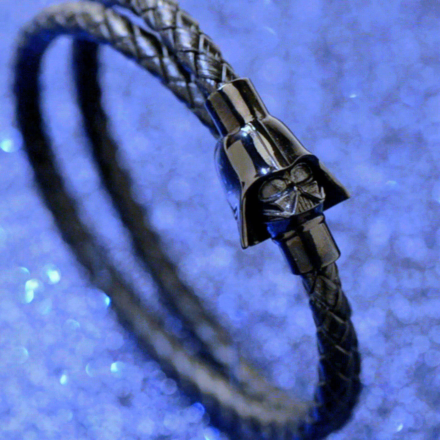 The Star Wars Darth Vader Double Wrap Bracelet by Cufflinks.com features black braided leather and a glossy helmet clasp with stainless steel accents—an iconic jewelry piece for fans.