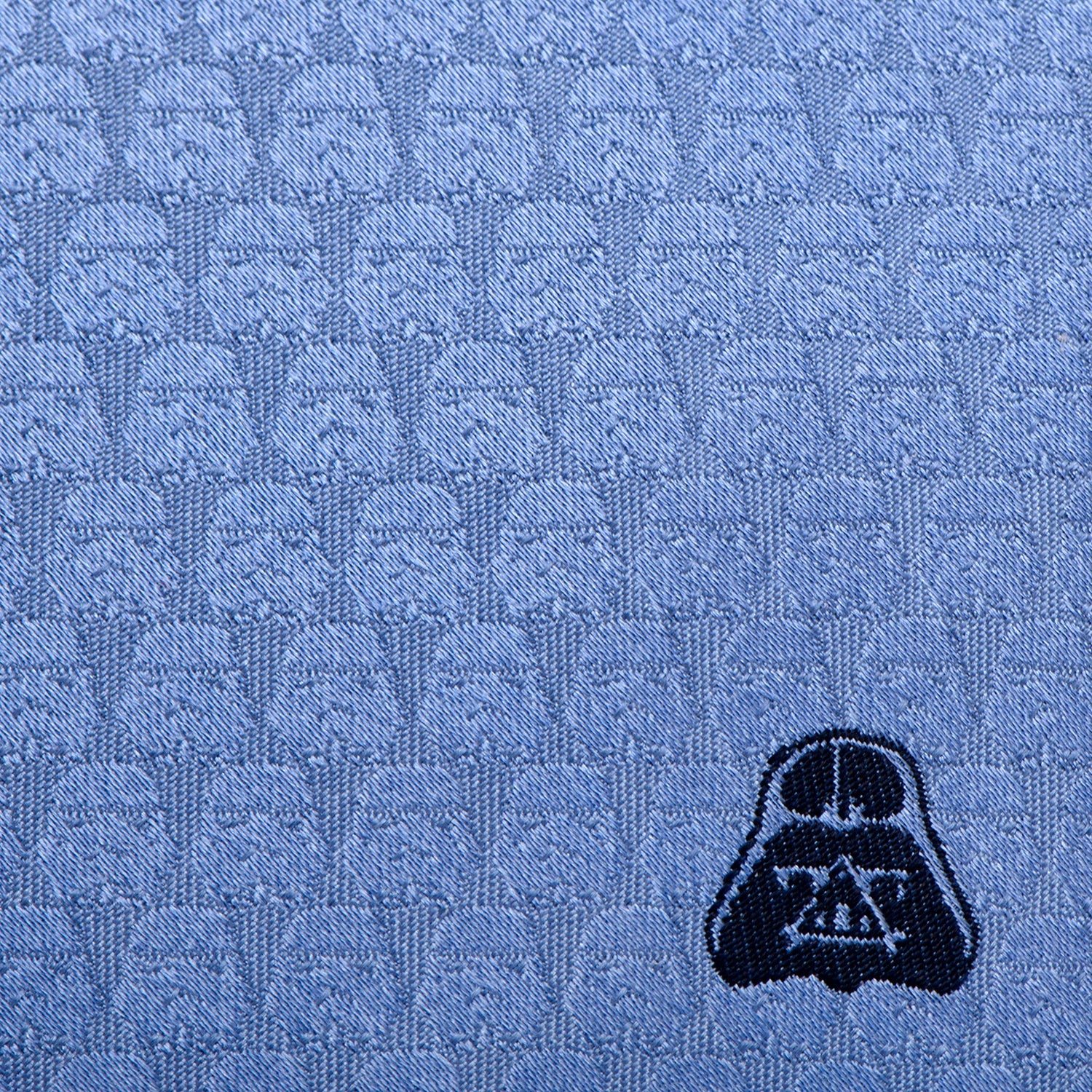 The Star Wars Darth Vader and Stormtroopers Imperial Force Blue Tie by Cufflinks.com features a subtle repeating Darth Vader pattern and a prominent Darth Vader head embroidered near the tip.