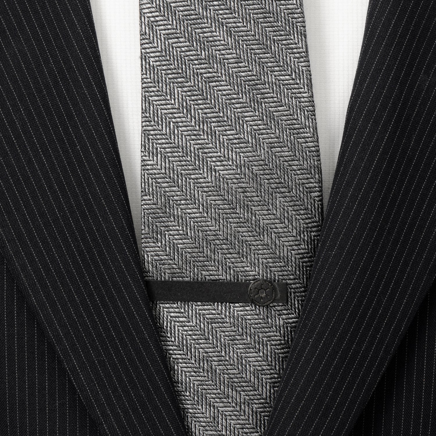 The Star Wars Imperial Crest Satin Black Tie Bar by Cufflinks.com features a black finish and embossed geometric emblem, inspired by the Imperial Symbol. Photographed on a white background.