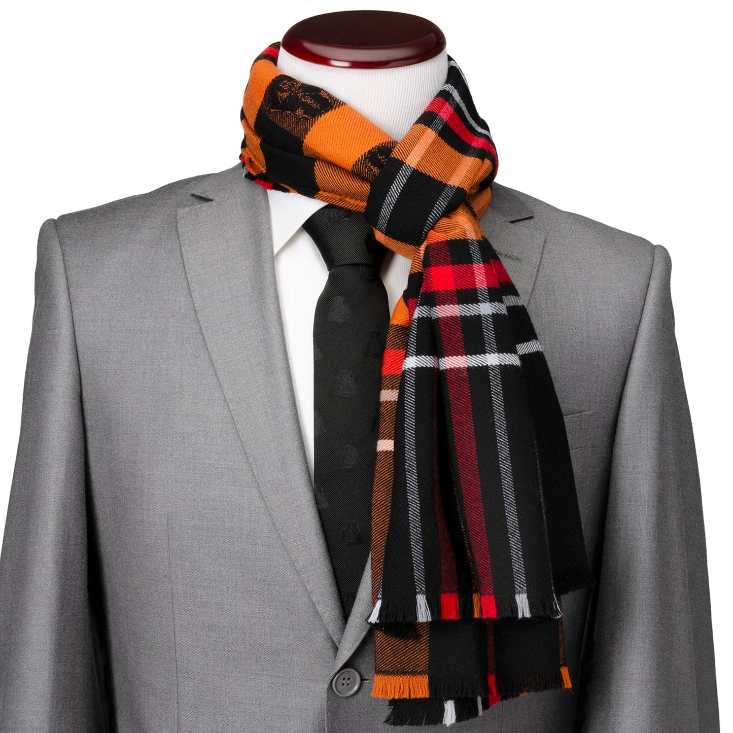 The Star Wars Darth Vader Black Tartan Scarf by Cufflinks.com features orange, black, red, and brown plaid, fringe edges, and Star Wars-inspired embroidered patches.