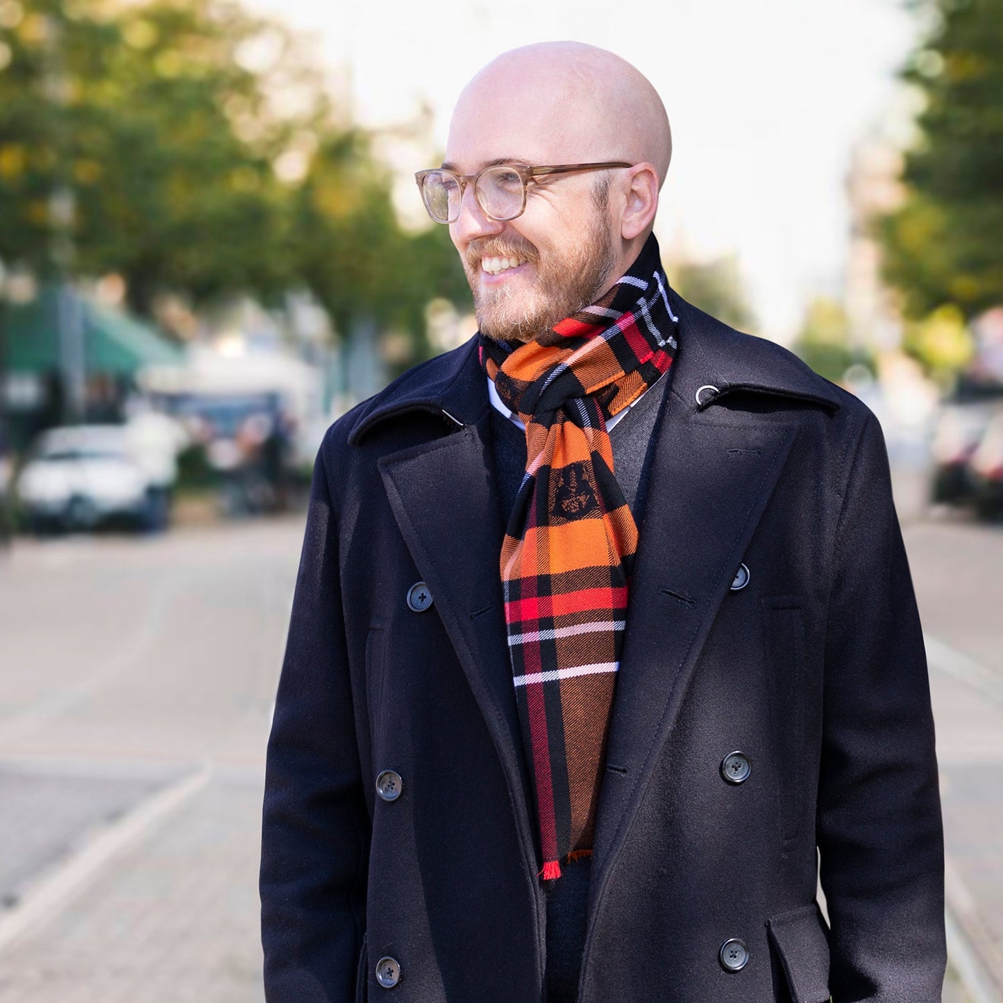 The Star Wars Darth Vader Black Tartan Scarf by Cufflinks.com features orange, black, red, and brown plaid, fringe edges, and Star Wars-inspired embroidered patches.