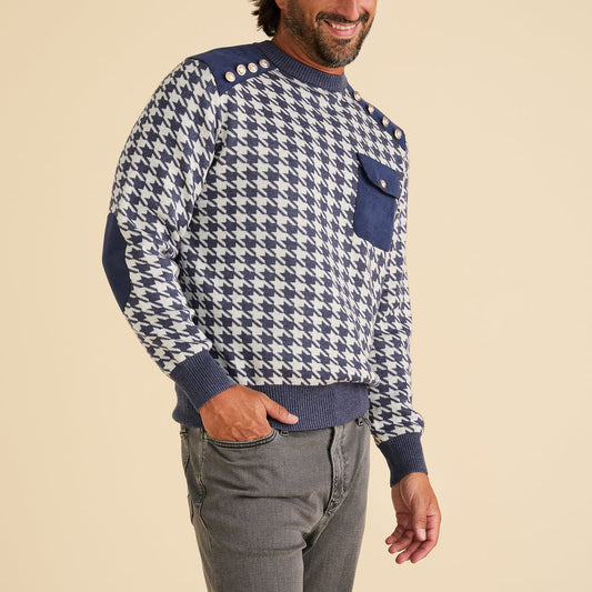 Man wearing the Inserch Houndstooth Crew Neck Sweater SW002-11 Navy Blue by Inserch, featuring blue and white houndstooth pattern, military shank buttons on the shoulder, chest pocket, accent panels, and paired with gray pants.