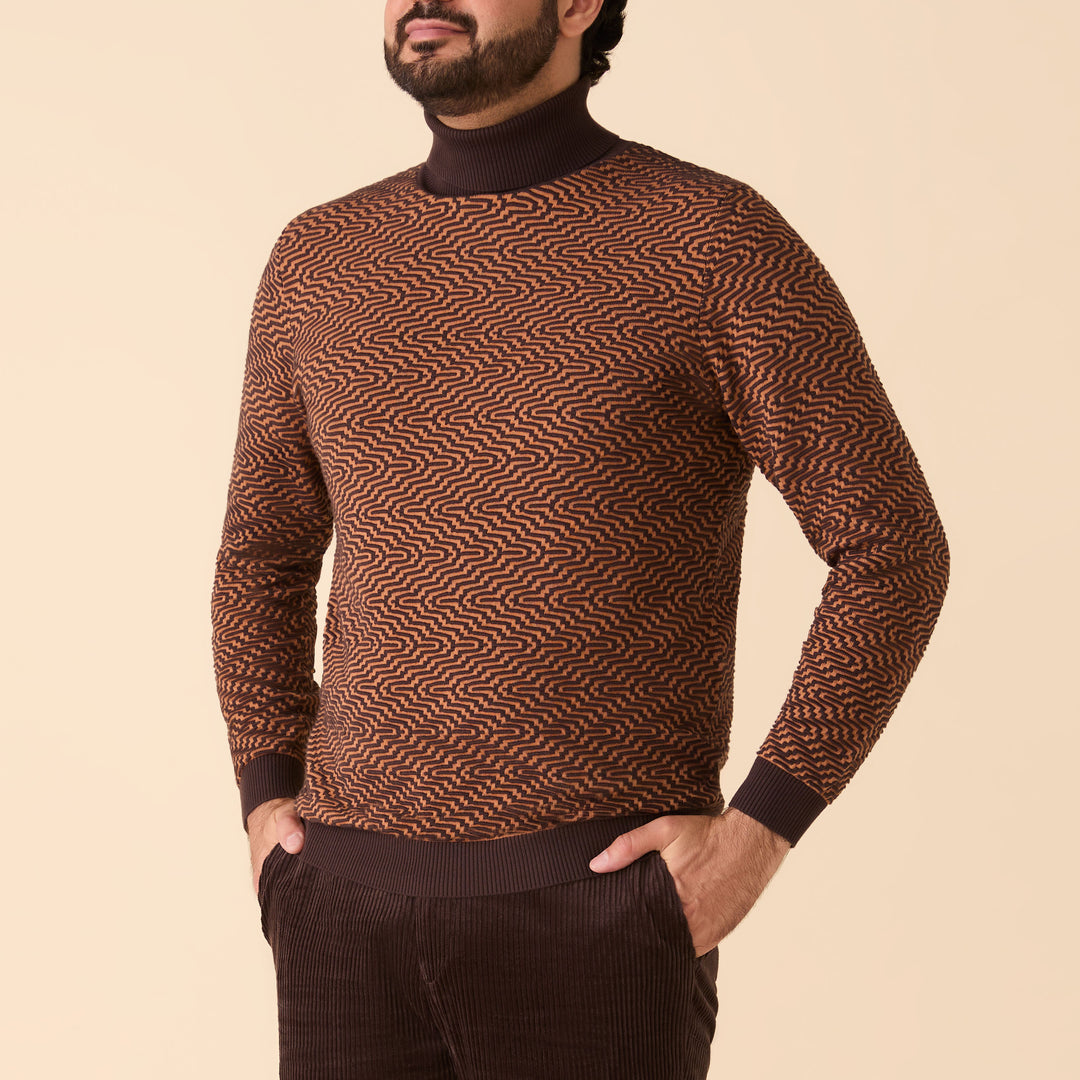 A man stands with his hands in his pockets against a neutral background, wearing the Inserch Intarsia Turtleneck Sweater SW304-00043 Espresso and dark brown pants.