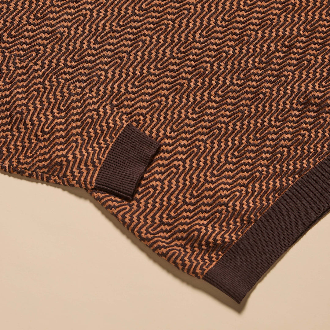 A man stands with his hands in his pockets against a neutral background, wearing the Inserch Intarsia Turtleneck Sweater SW304-00043 Espresso and dark brown pants.