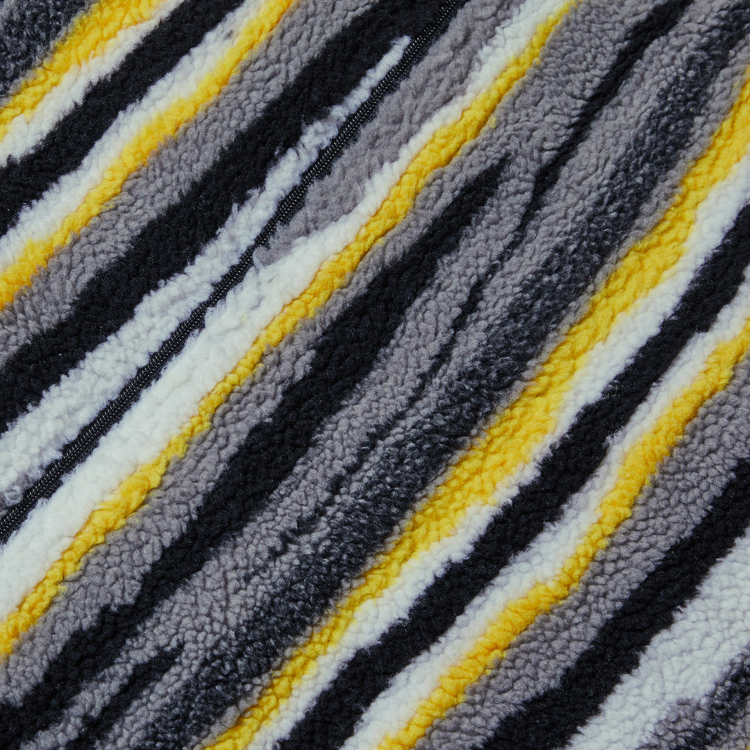 A person wears the Inserch Stripe Baseball Jacket SW610-01 Black by Inserch, featuring black, white, gray, and yellow vertical stripes and a classic baseball rib collar over a black turtleneck.