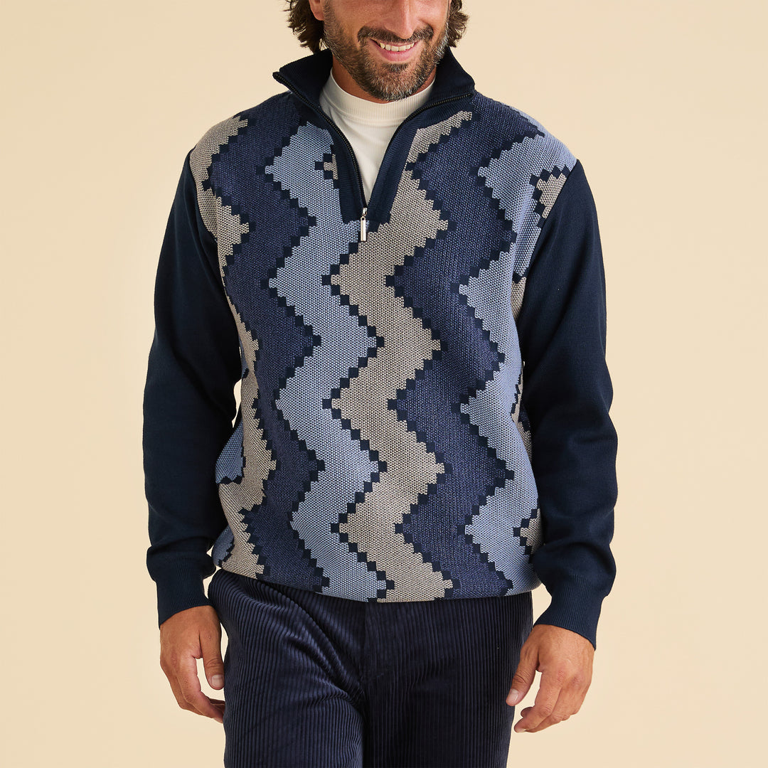 A man wears the Inserch Zig-Zag Half Zip Sweater SW613-11 Navy Blue over a white shirt and navy pants, standing against a beige background.