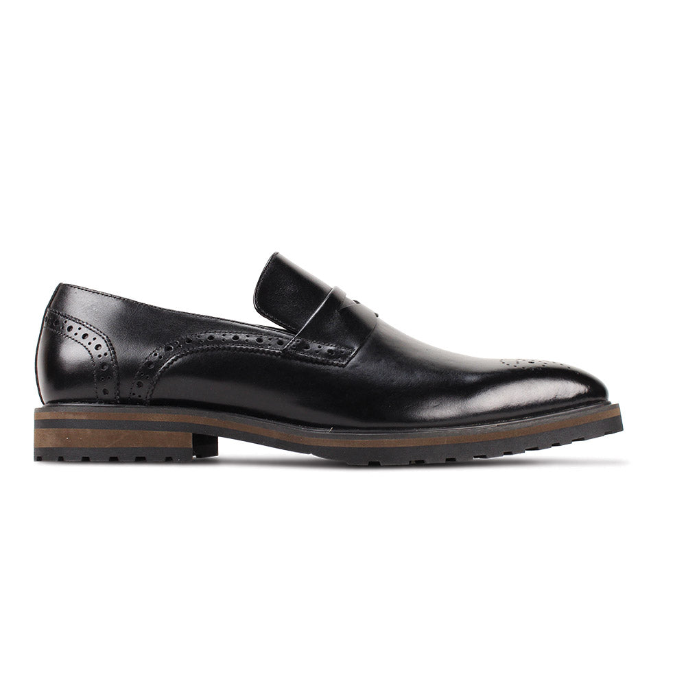 The GIOVANNI Giovanni Silvio Black Leather Shoes feature slip-on styling, brogue detailing, a brown layered sole, and a low heel, shown here against a white background.