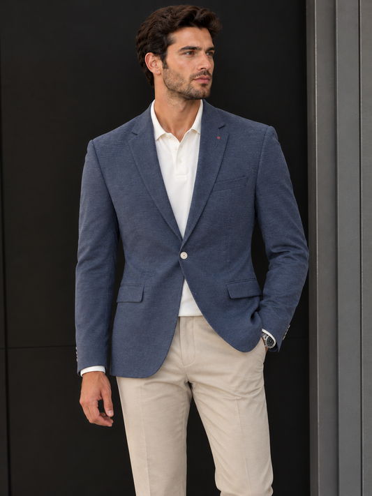 Inserch Blazer 562 Navy (FINAL SALE) (SIZE 3XL ONLY) in navy blue with a textured finish hanging on a wooden hanger among other garments on a clothing rack.