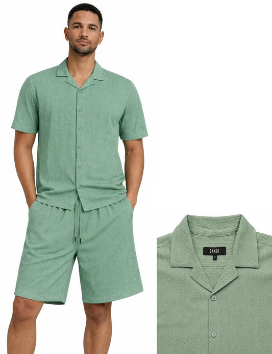 A man wears the Bassiri Sage 2pc Set T 126 by Bassiri, featuring a light green short-sleeve button-up shirt and matching drawstring shorts. An inset displays a close-up of the shirt’s collar and label.