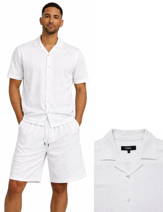 A man wears the Bassiri White 2pc Set T 126—short-sleeve button-up shirt and matching drawstring shorts. Close-up highlights the shirt’s collar and Bassiri brand label.
