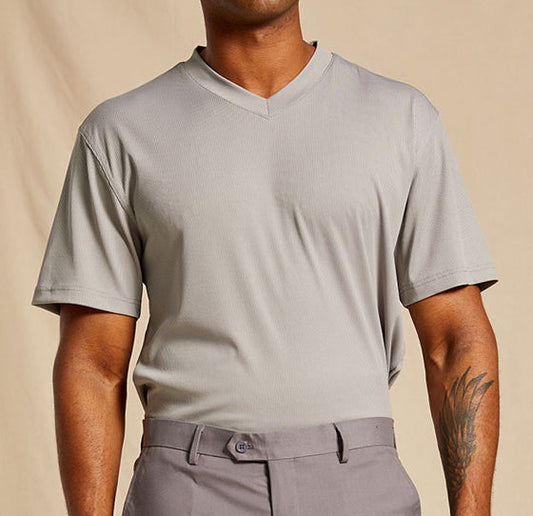 A man wears the Inserch Rib V Neck T-Shirt T300-00004 Light Grey by Inserch, tucked into matching gray trousers, standing against a plain beige background.