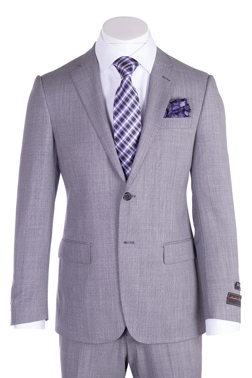 The Tiglio Luxe Novello Light Gray Birdseye Pure Wool Men’s Suit TIG1018 by Tiglio Luxe is showcased on a mannequin, featuring classic notch lapels, a crisp white dress shirt, and complemented by a purple plaid tie with a matching pocket square—an elegant ensemble that exemplifies the sophistication of Italian-inspired men’s tailoring.