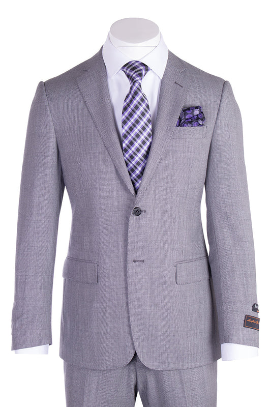 The Tiglio Luxe Novello Light Gray Birdseye Pure Wool Men’s Suit TIG1018 by Tiglio Luxe is showcased on a mannequin, featuring classic notch lapels, a crisp white dress shirt, and complemented by a purple plaid tie with a matching pocket square—an elegant ensemble that exemplifies the sophistication of Italian-inspired men’s tailoring.