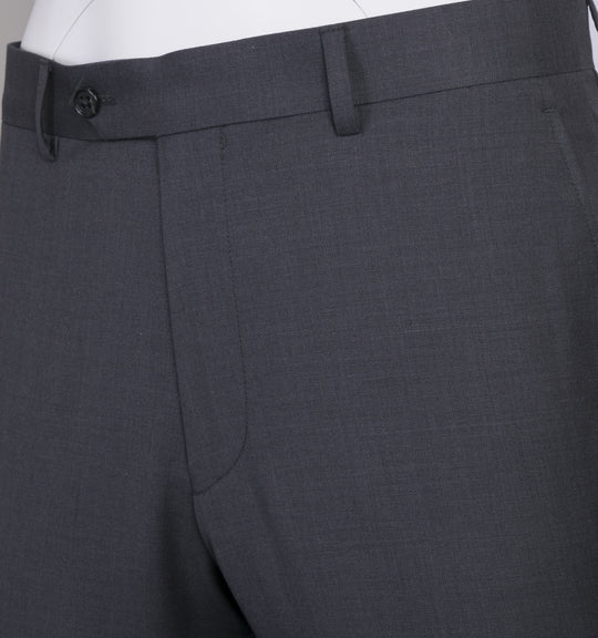 The Tiglio Luxe Novello Medium Gray Pure Wool Men’s Suit TIG1008 features a white dress shirt, striped tie, blue flower lapel pin, and a left sleeve label—Tiglio Luxe luxury fashion for men, displayed on a headless mannequin.