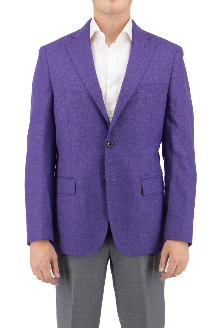 A person wearing the Tiglio Luxe Violet Dolcetto Modern Fit Pure Wool Jacket TL3375, a finely crafted garment from Italian fabrics, paired with a white shirt and gray pants, stands with their hands by their sides against a plain white background.