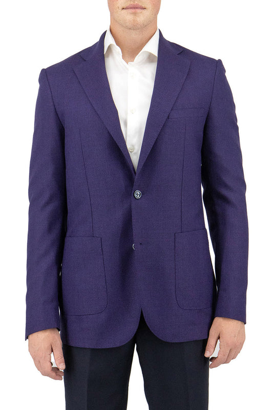 A person wearing the Tiglio Luxe Purple Veneto/THP Slim Fit Half Lined, Pure Wool Jacket TL3376 stands against a plain white background, highlighting the elegance of Italian men's fashion and its rich sartorial heritage.