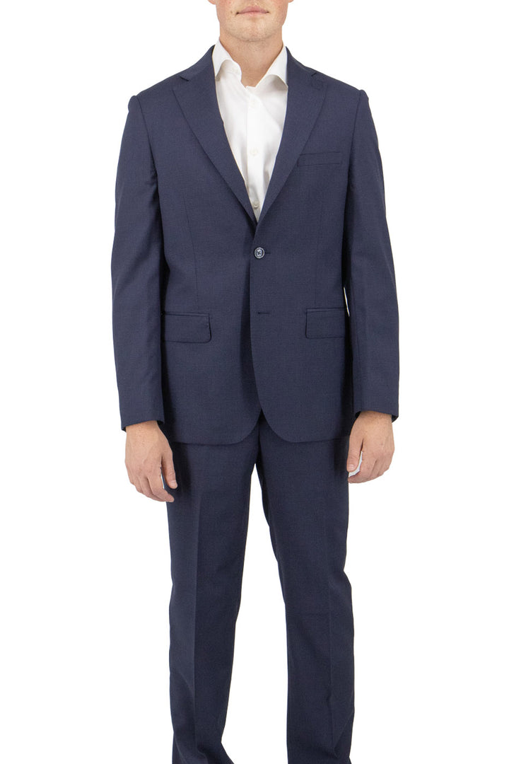A man wears the Tiglio Luxe Navy Micro-Design Porto Slim Fit Pure Wool Suit TL4055 with a white shirt, standing against a plain white background to showcase the elegance of Tiglio Luxe men's clothing.
