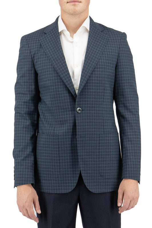 A man is dressed in the Tiglio Luxe Navy and Green Mini Windowpane Dolcetto/THP Modern Fit Half Lined, Pure Wool Jacket TL4228 by Tiglio Luxe, layered over a crisp white shirt and paired with black pants, standing against a plain white background.