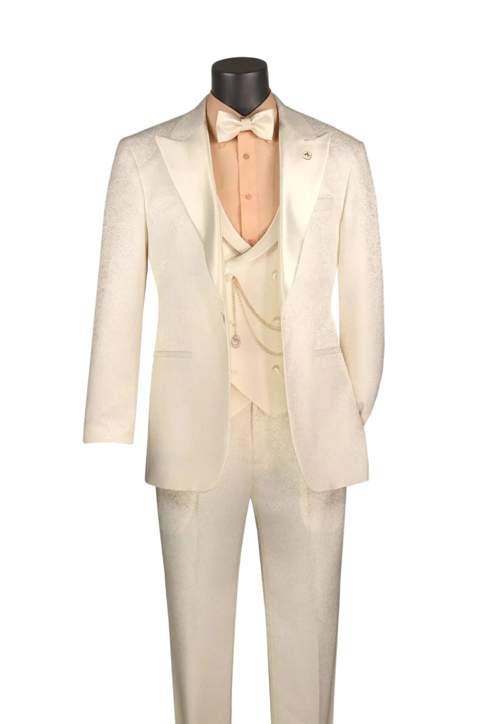 The Slim Fit Pearl 3 Piece Jacquard Pattern Peak Lapel Tuxedo TVMF-2 by Vinci Suits is shown with a white bow tie, peach shirt, vest, and gold pocket watch chain on a mannequin.